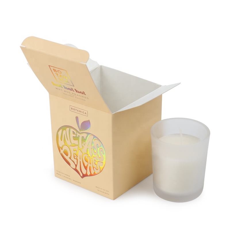 printed folding carton shown open beside its candle product