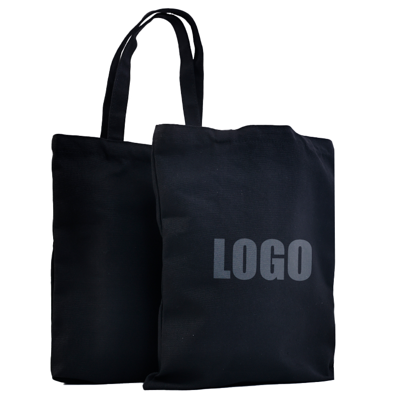 black canvas tote bag with understated gray logo print - view 1