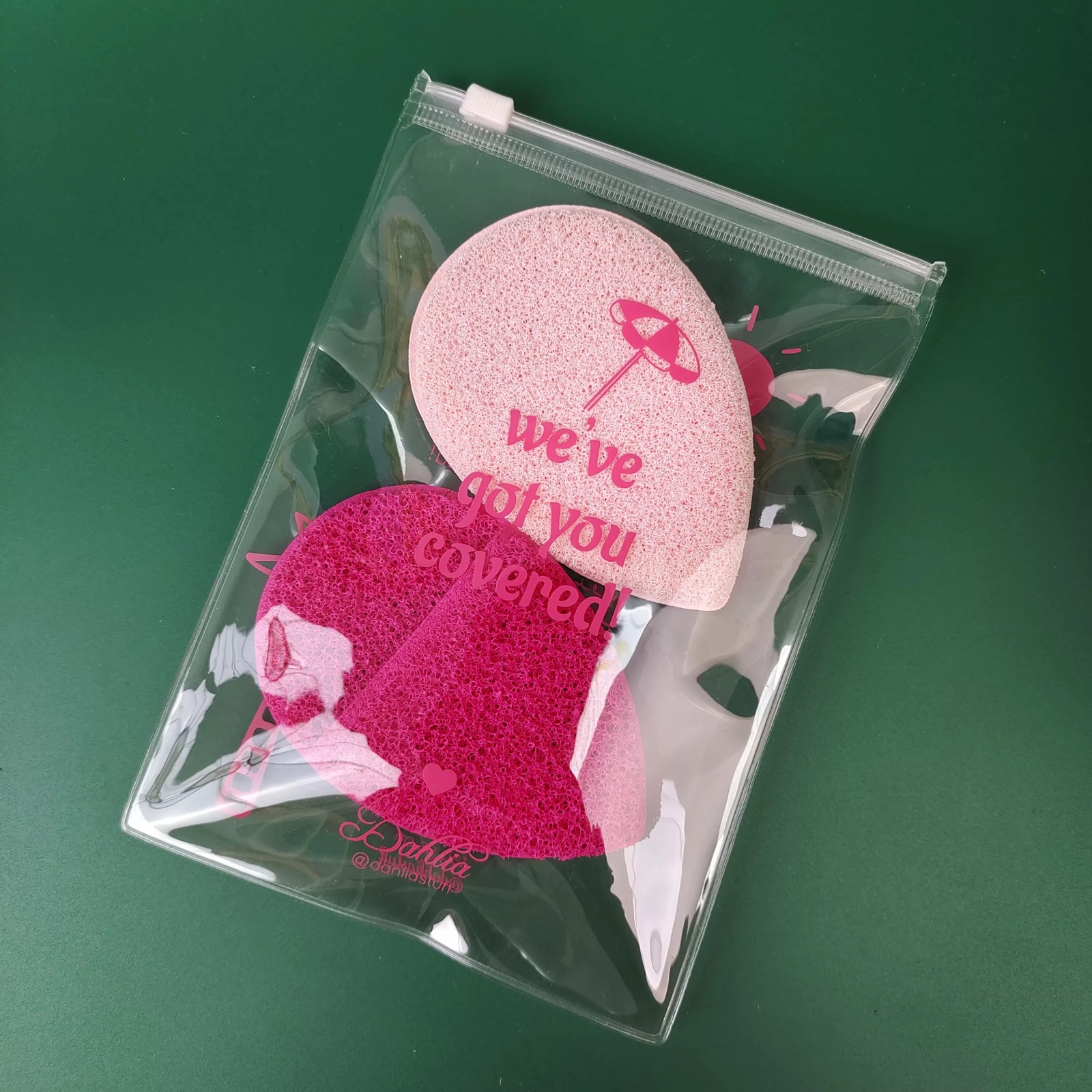 clear PVC slider pouch holding pink beauty sponges and accessories
