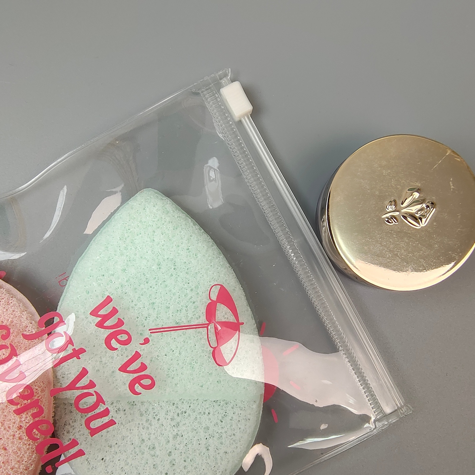clear PVC slider pouch holding pink beauty sponges and accessories - view 6