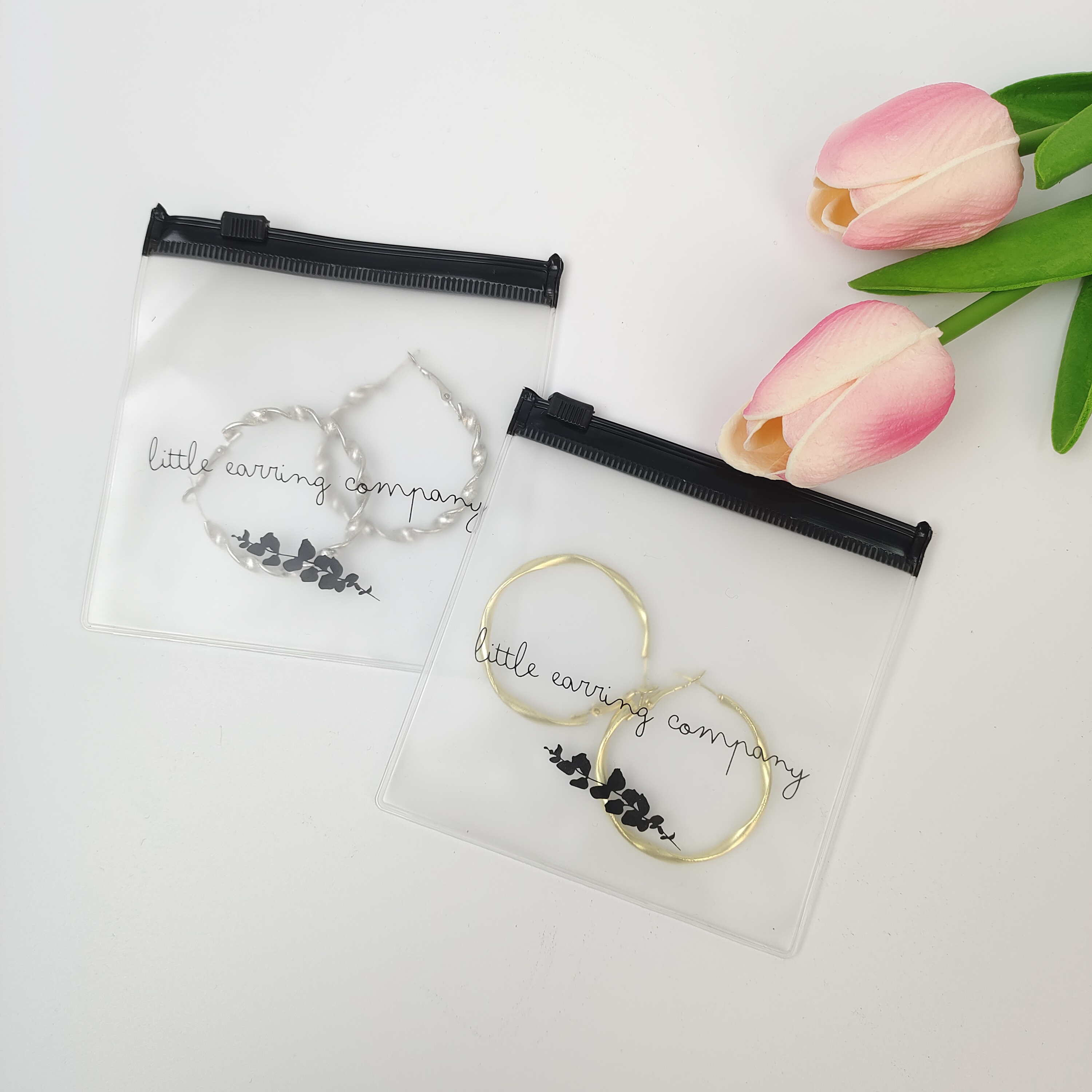 small clear PVC zipper pouch displaying earrings - view 1