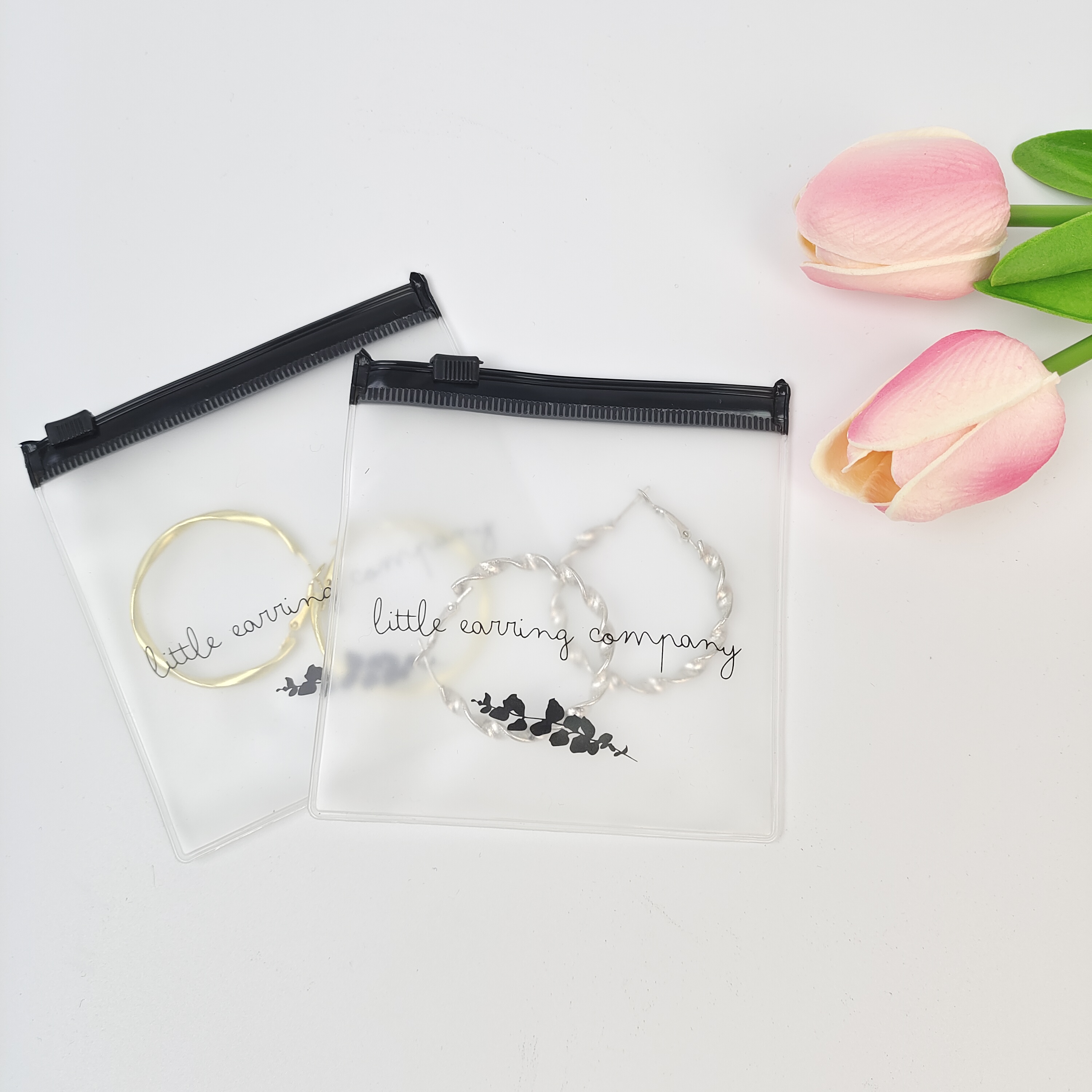 small clear PVC zipper pouch displaying earrings - view 4