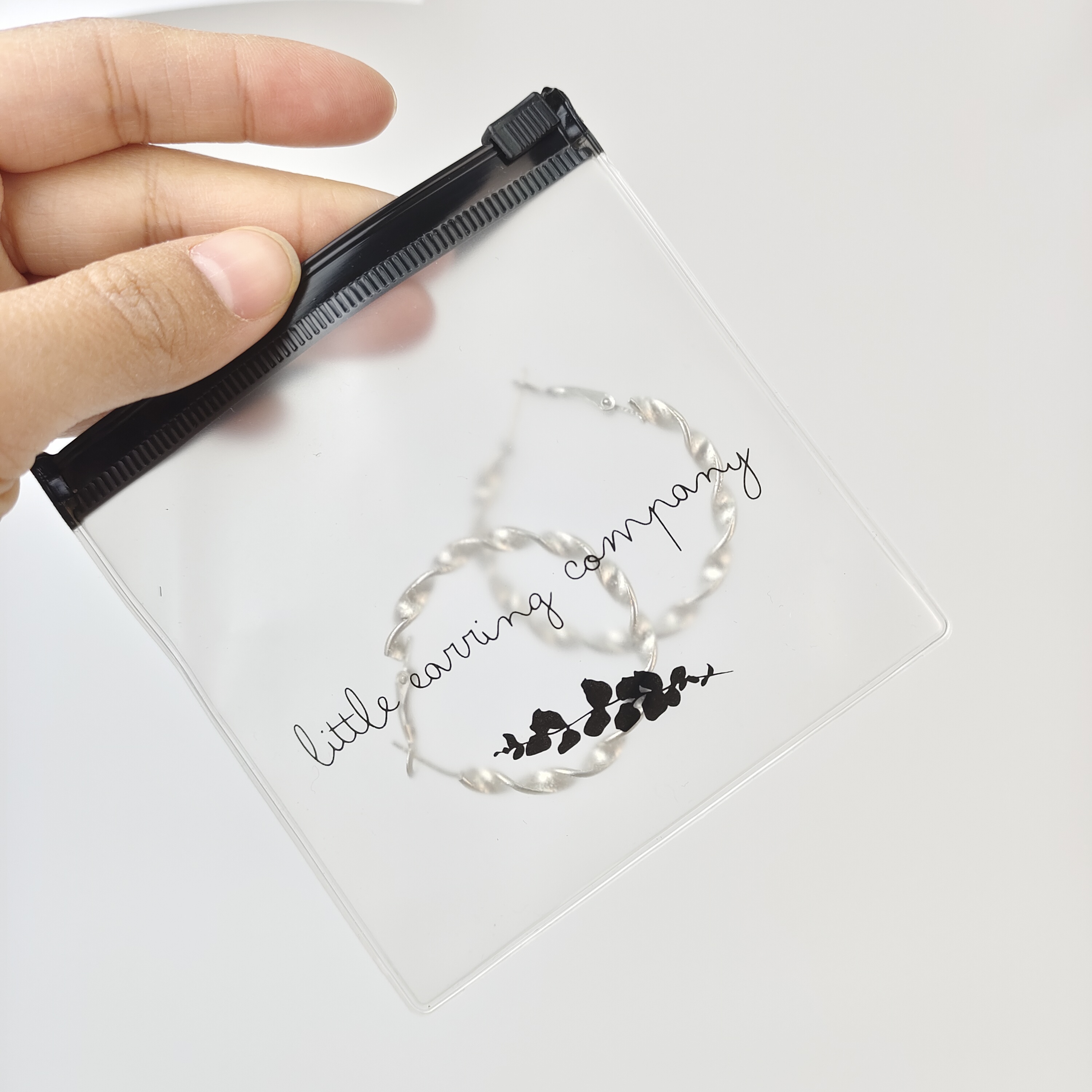 small clear PVC zipper pouch displaying earrings - view 5