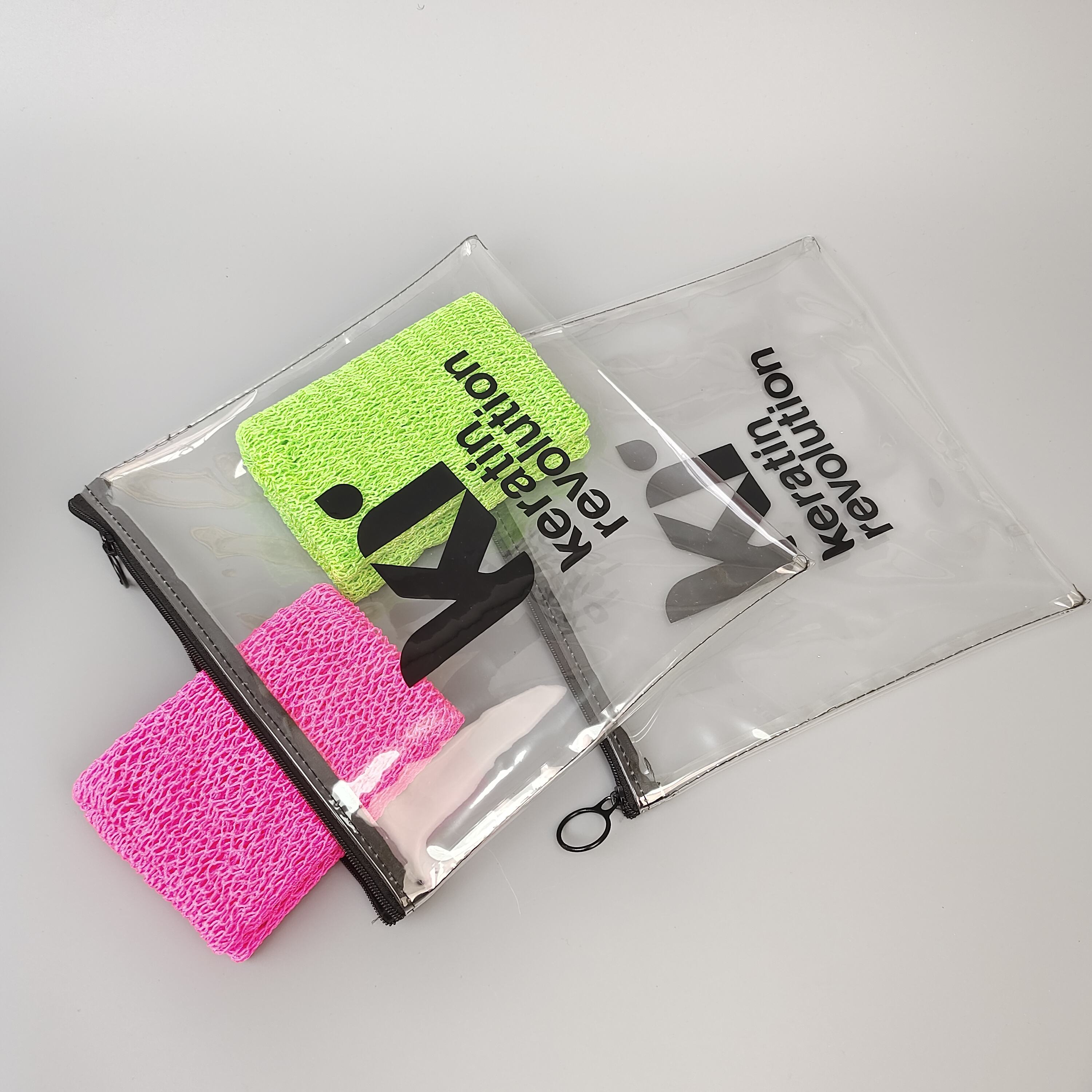 clear printed PVC zipper pouch holding colorful hair care accessories - view 6