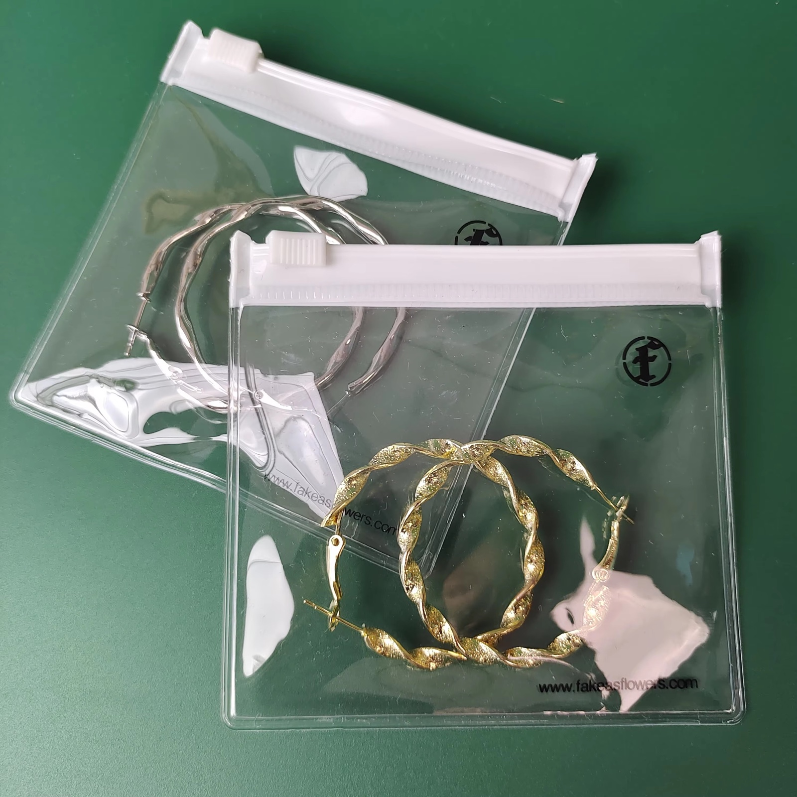 clear PVC jewelry pouches with white zipper and printed black logo