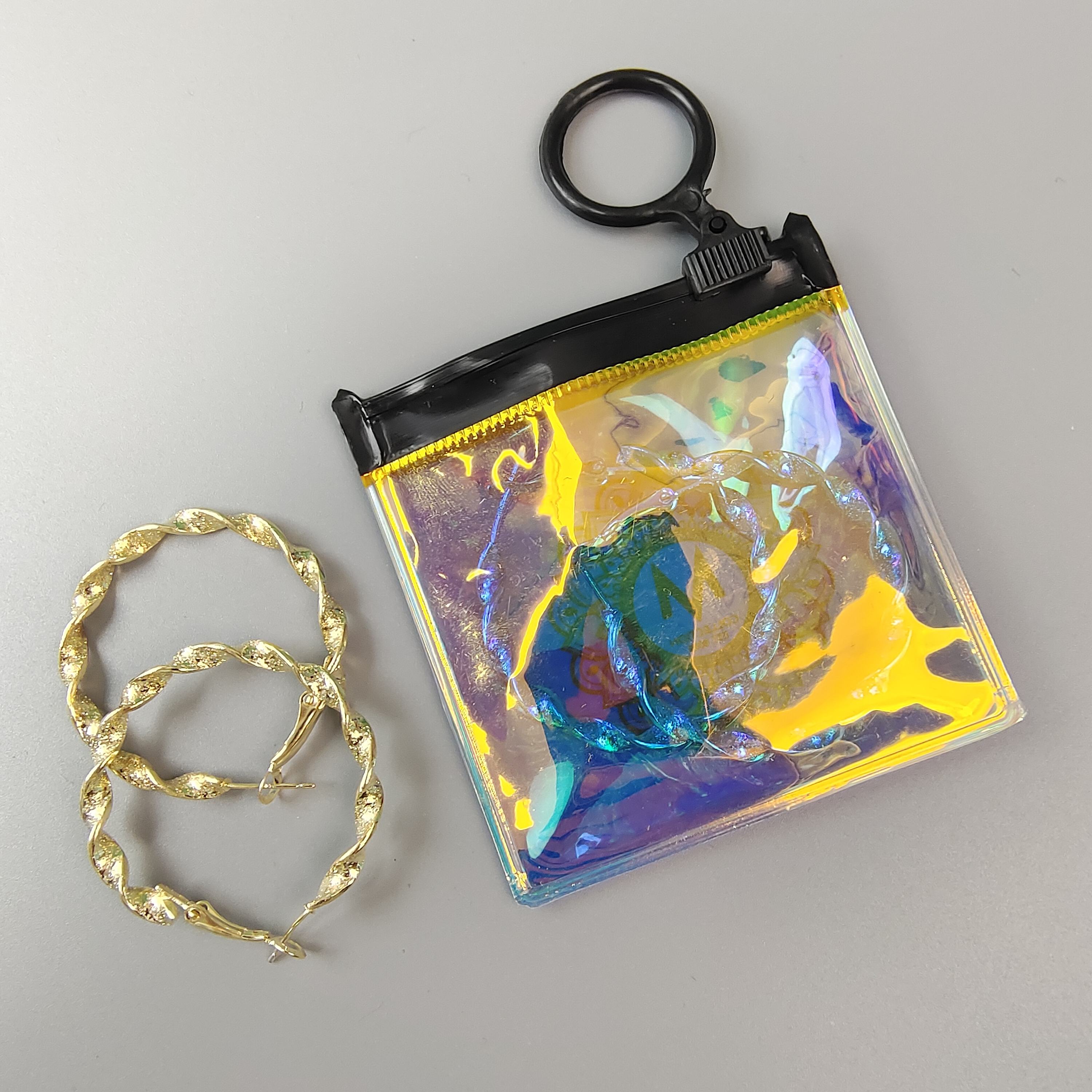 small holographic PVC jewelry pouch with circular black ring pull - view 4