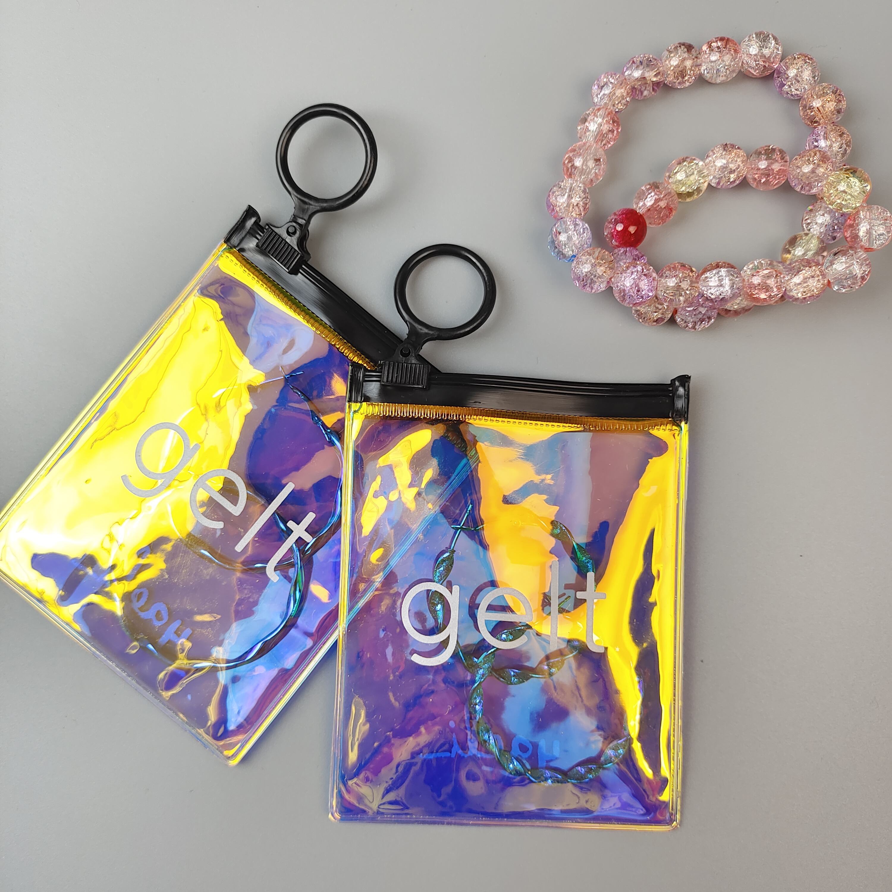 small holographic PVC jewelry pouch with circular black ring pull - view 5