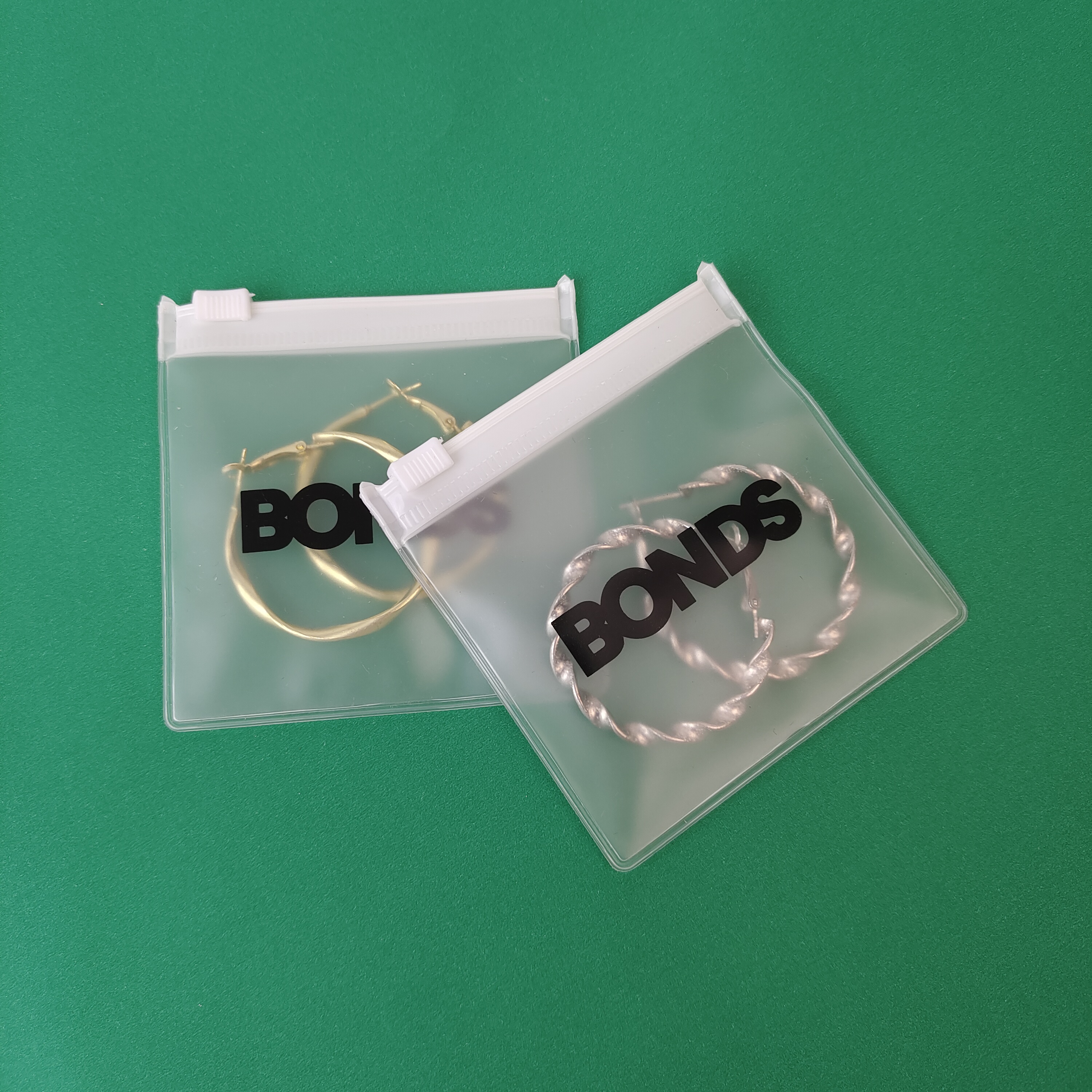 frosted PVC zipper pouch displaying earrings