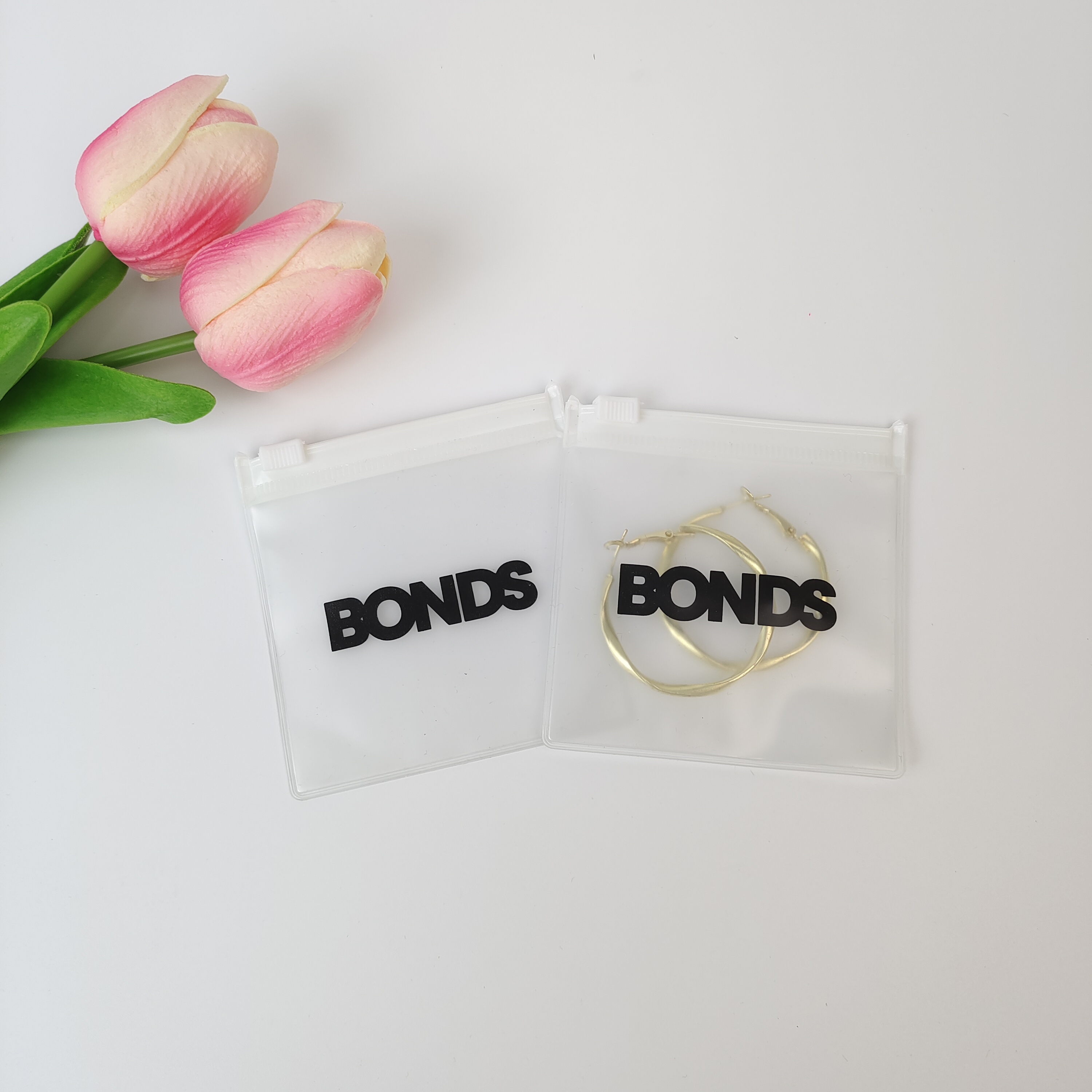 frosted PVC zipper pouch displaying earrings - view 2