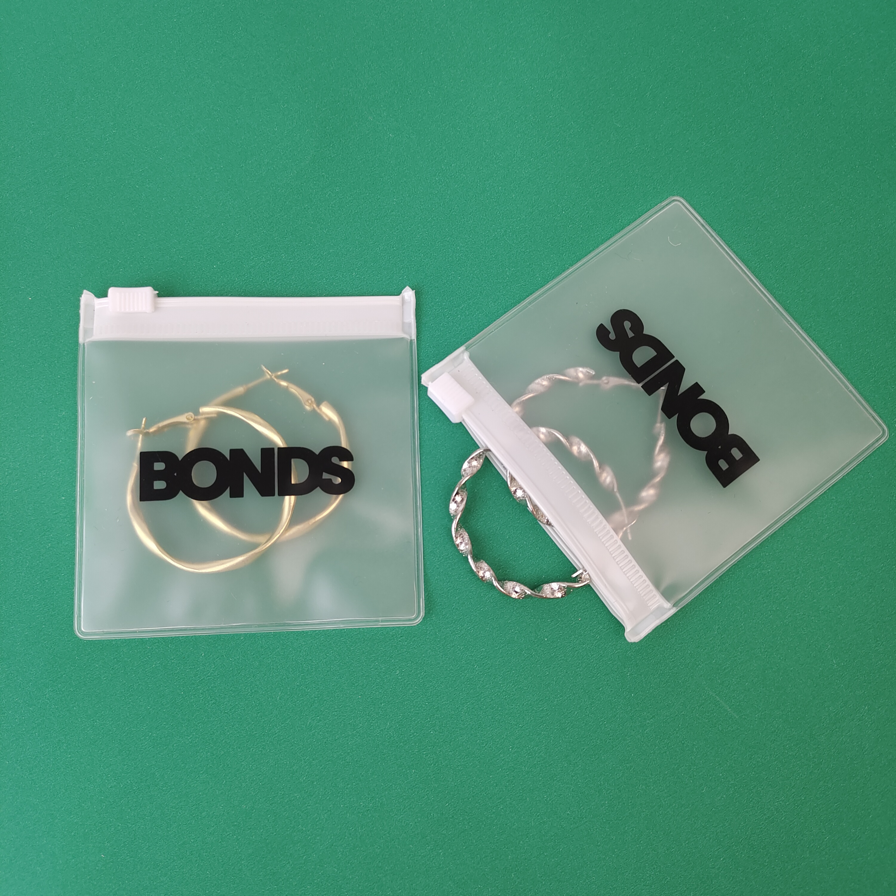 frosted PVC zipper pouch displaying earrings - view 5