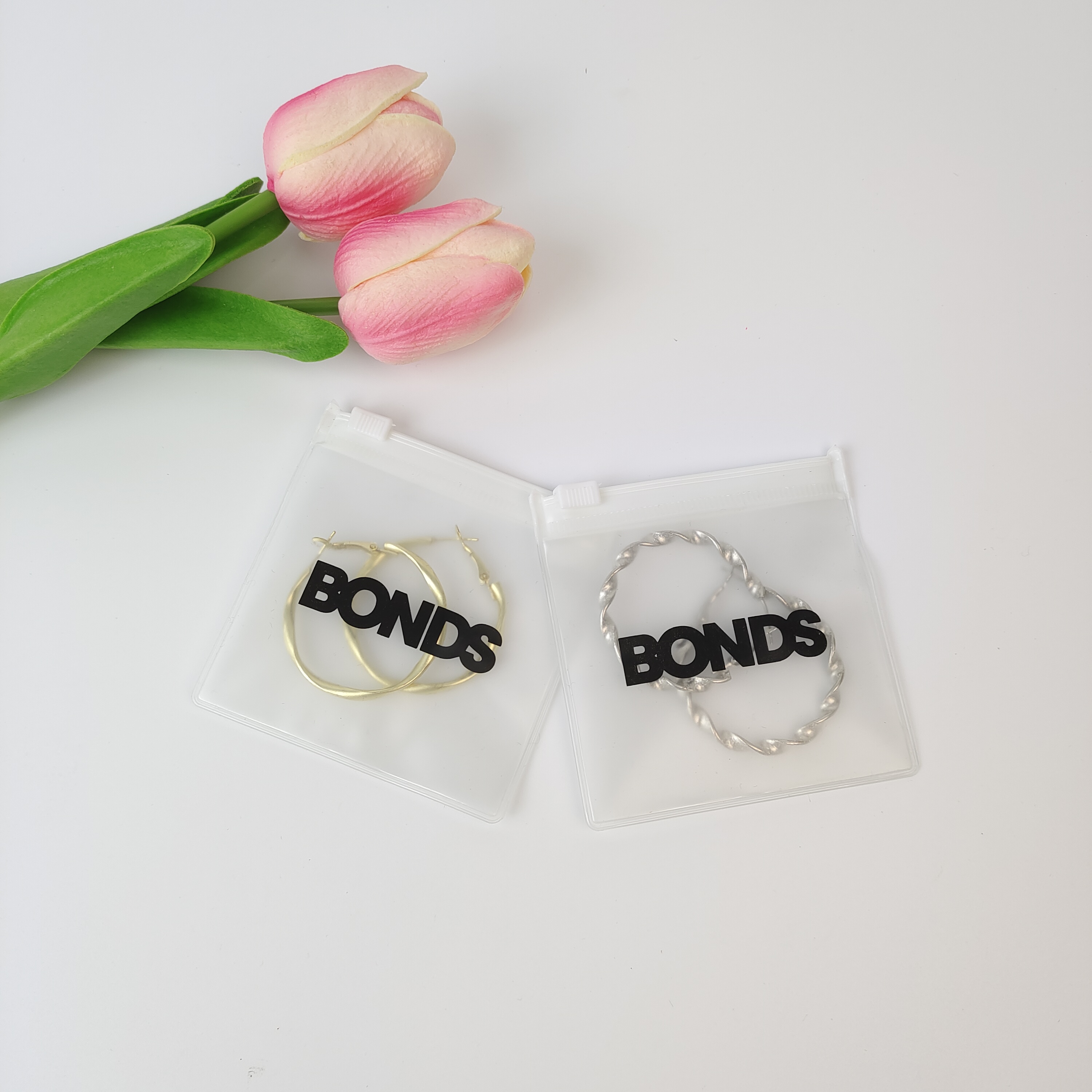 frosted PVC zipper pouch displaying earrings - view 6