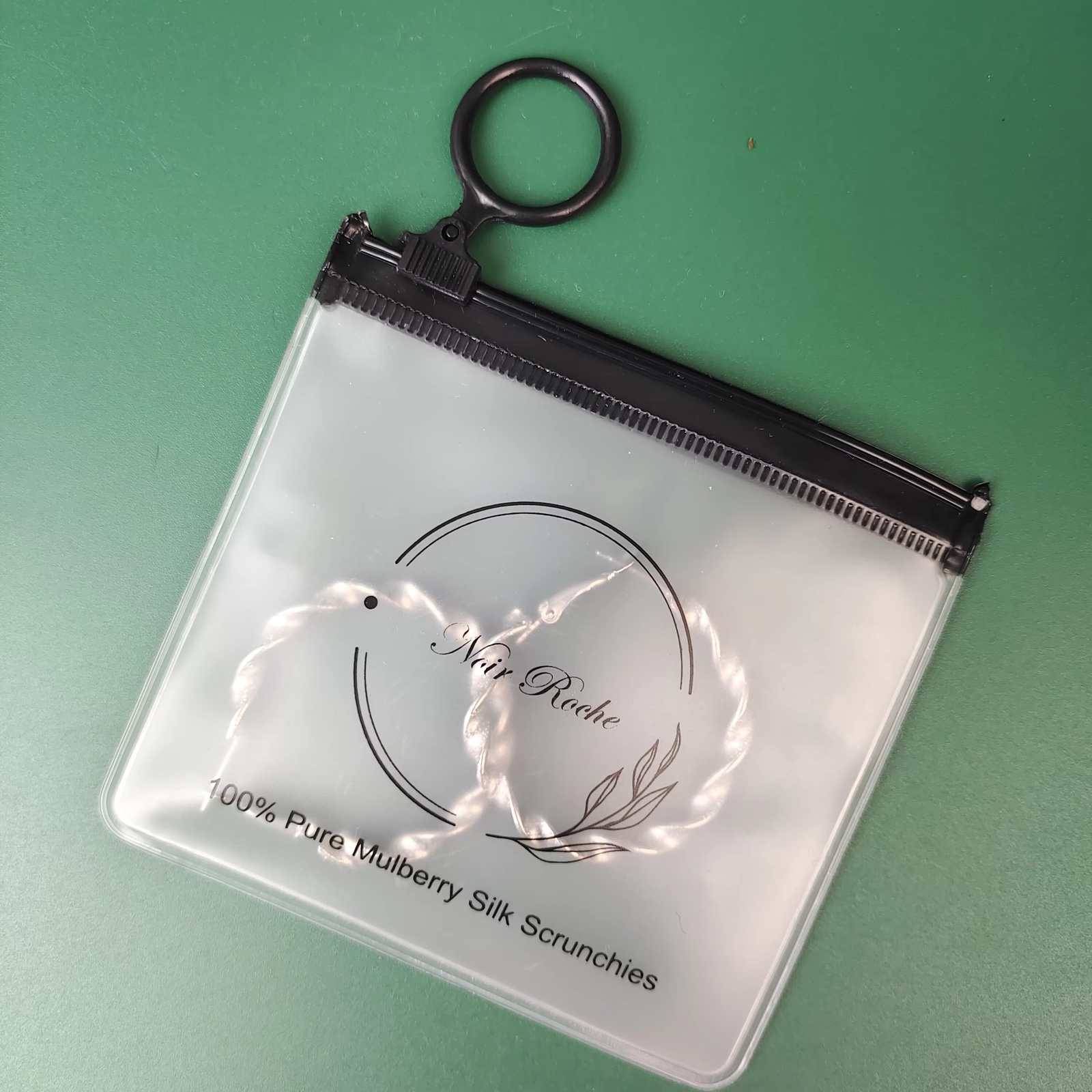frosted PVC ring pull pouch containing jewelry and hair accessories - view 2