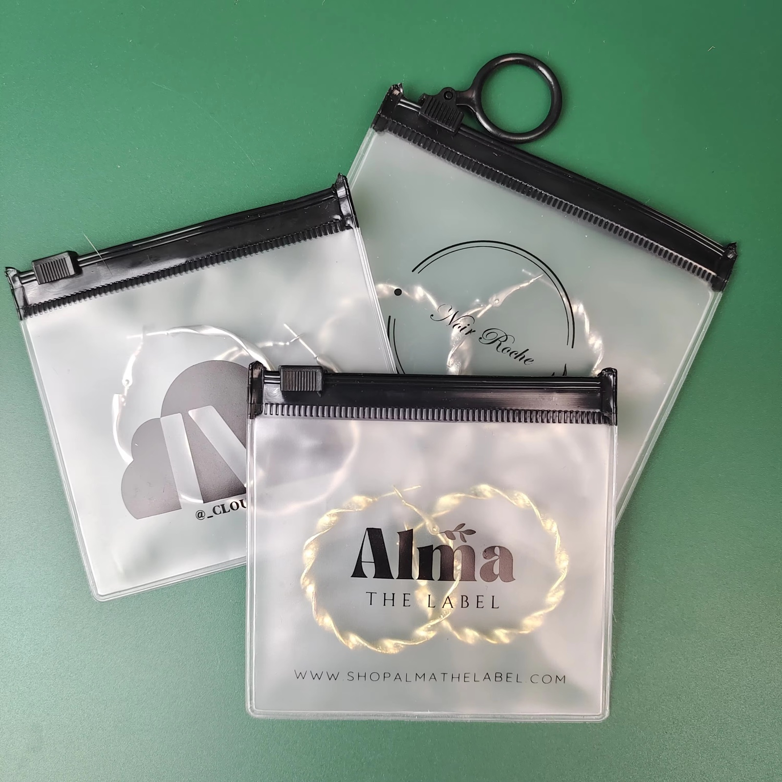 frosted PVC ring pull pouch containing jewelry and hair accessories - view 4