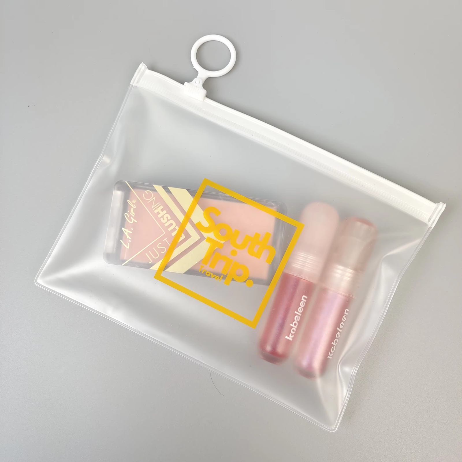 frosted PVC travel pouch with white zipper and circular ring pull - view 4