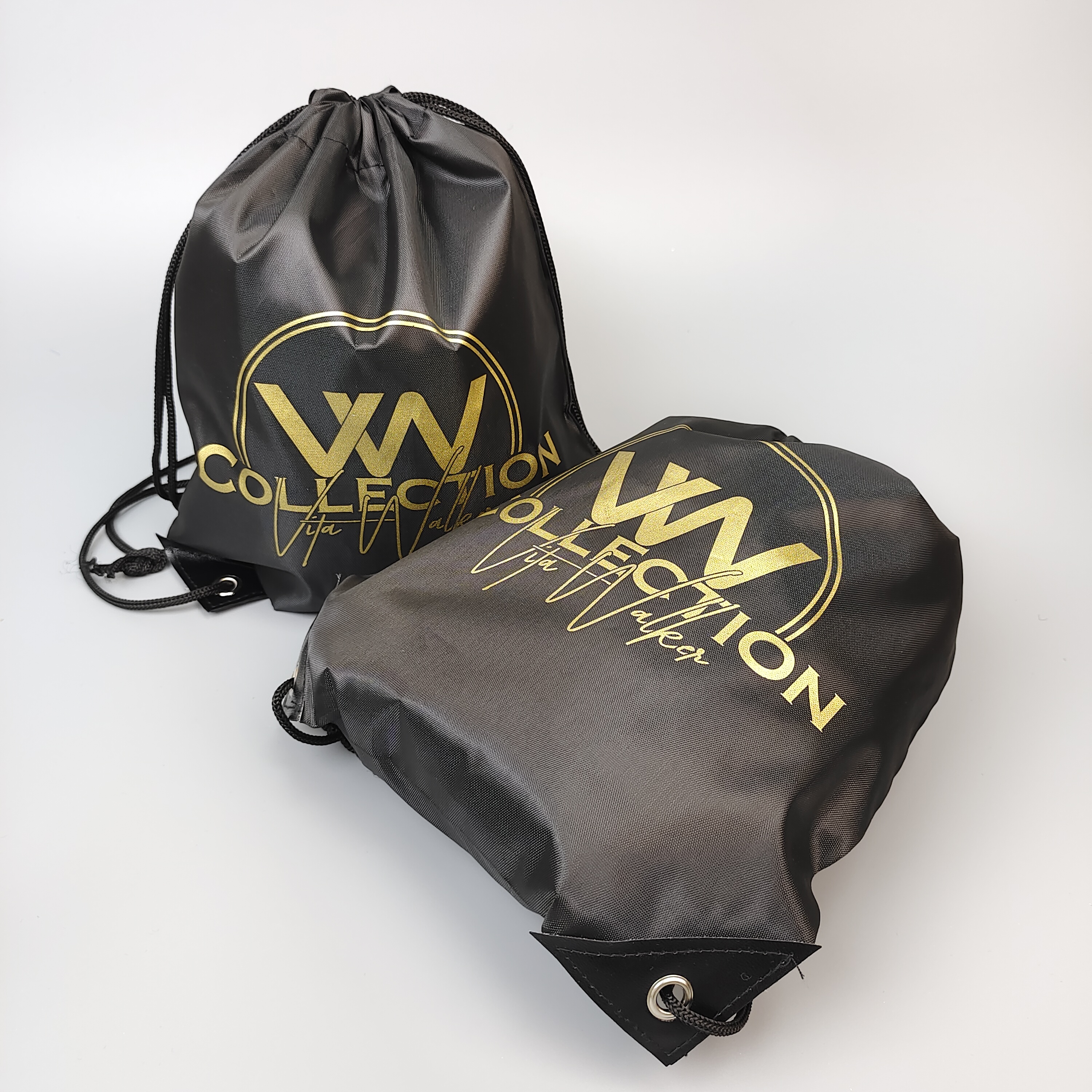 black polyester drawstring backpack with gold-colored logo artwork - view 2