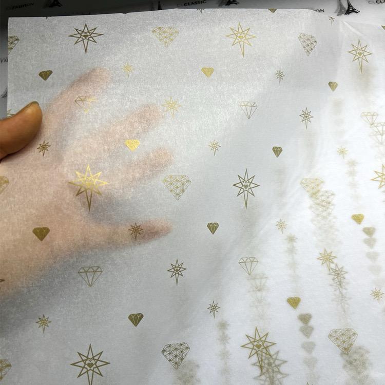white translucent tissue paper with gold star and diamond pattern