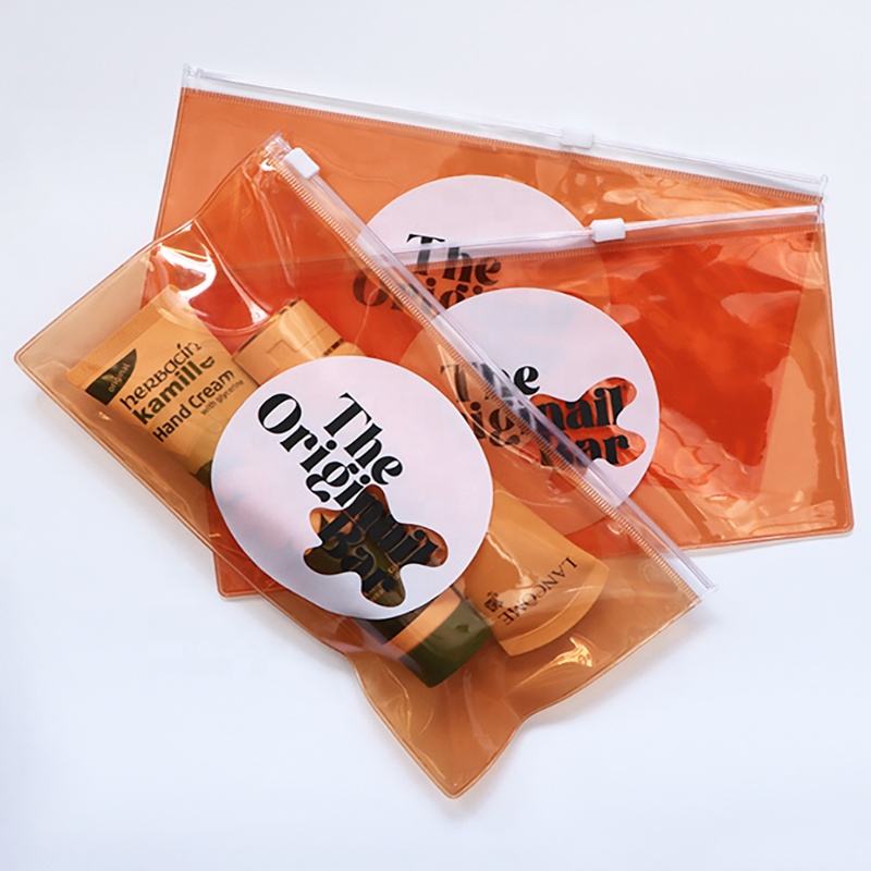 orange transparent PVC toiletry pouch set with white slider closures - view 1