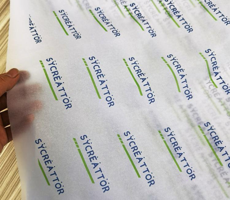 white tissue paper with repeating blue and green custom logos