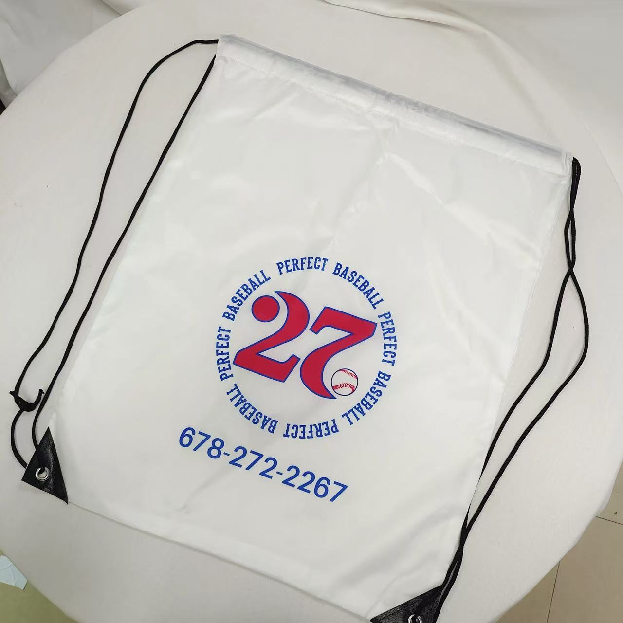 white custom baseball polyester drawstring bag with blue and red logo